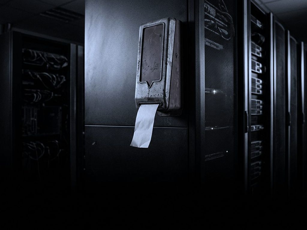 A battered take-a-number ticket dispenser bolted to a server rack in a dark data centre, one blank ticket hanging out.