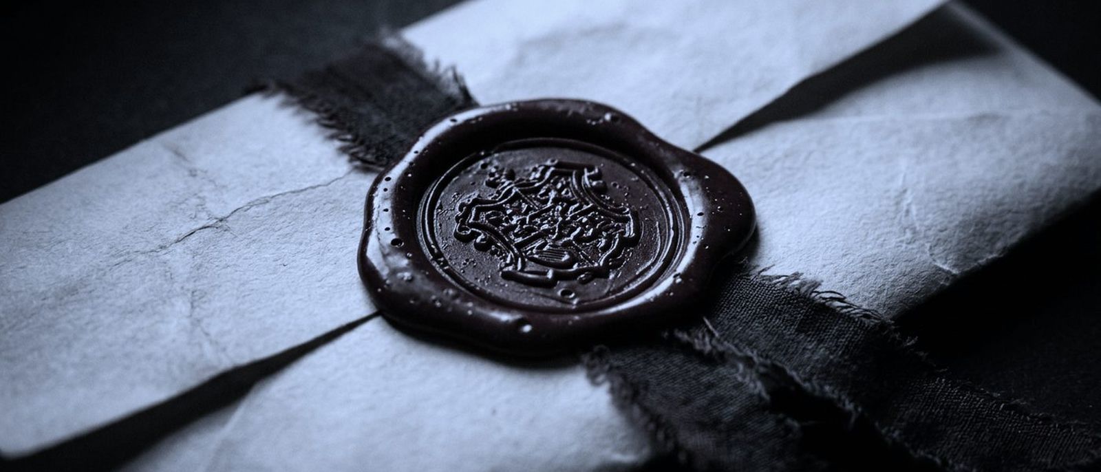 A heavy mechanical date stamp resting on a thick stack of carbon copy forms.