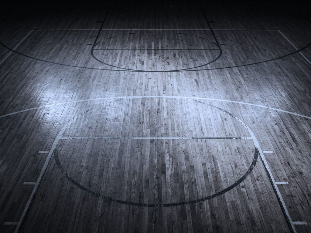 An empty indoor court seen from directly overhead, boundary lines painted on polished wood.