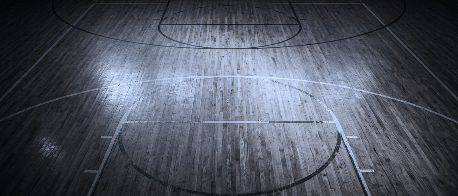 An empty indoor court seen from directly overhead, boundary lines painted on polished wood.