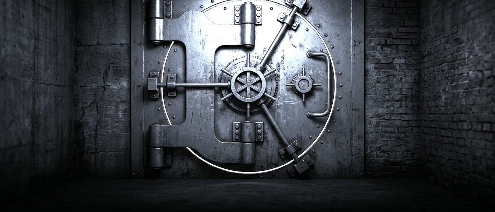 A closed bank vault door in a dark basement, a thin line of light along its edge.